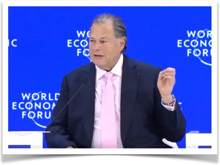 Salesforce CEO Marc Benioff gesturing while speaking on a panel at the World Economic Forum in Davos